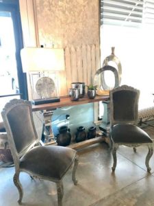 Grey Sofa chairs with antique artifacts on it
