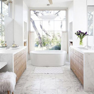 Beautifully designed white marble bathroom with bathtub with a large window