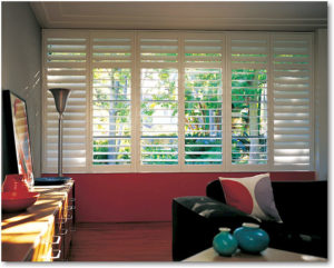 Hybrid shutters overlooking the garden area from the living room