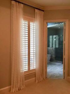 plantation shutters window with curtain